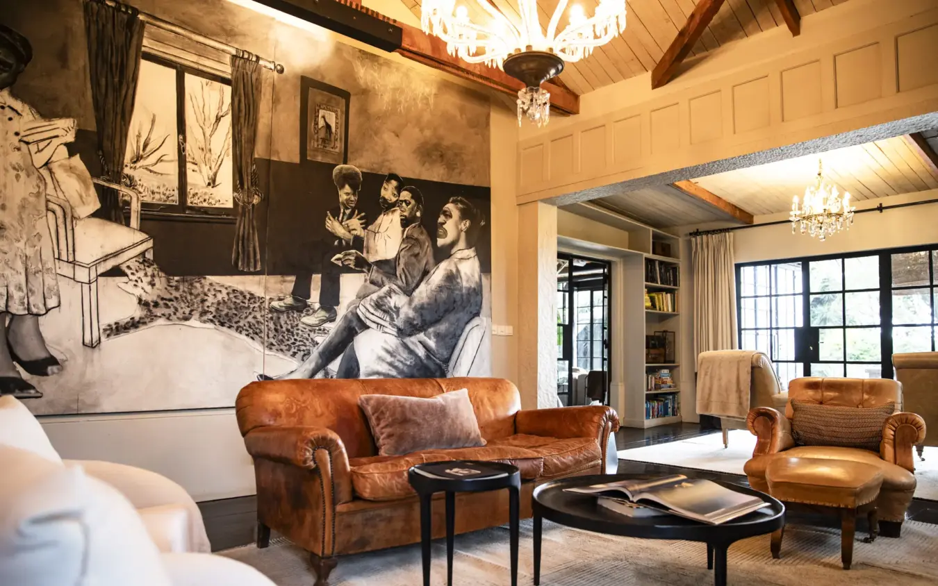 Luxury lounge with cognac leather seating and oversized black and white mural art, Segera, Laikipia Highlands, Kenya
