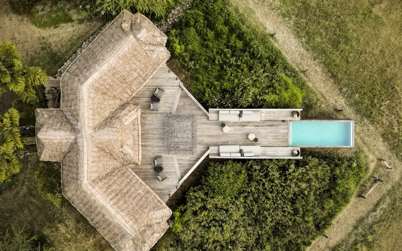Aerial view of luxury villa with pool surrounded by woodland gardens, Segera, Laikipia Highlands, Kenya