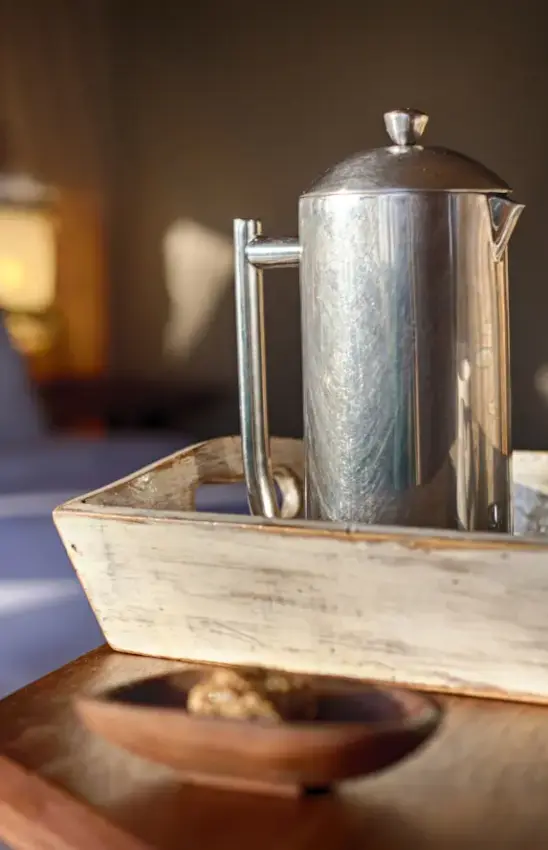 Silver coffee pot on wooden tray with morning light, Serian Serengeti Mobile Kusini, Serengeti National Park, Tanzania