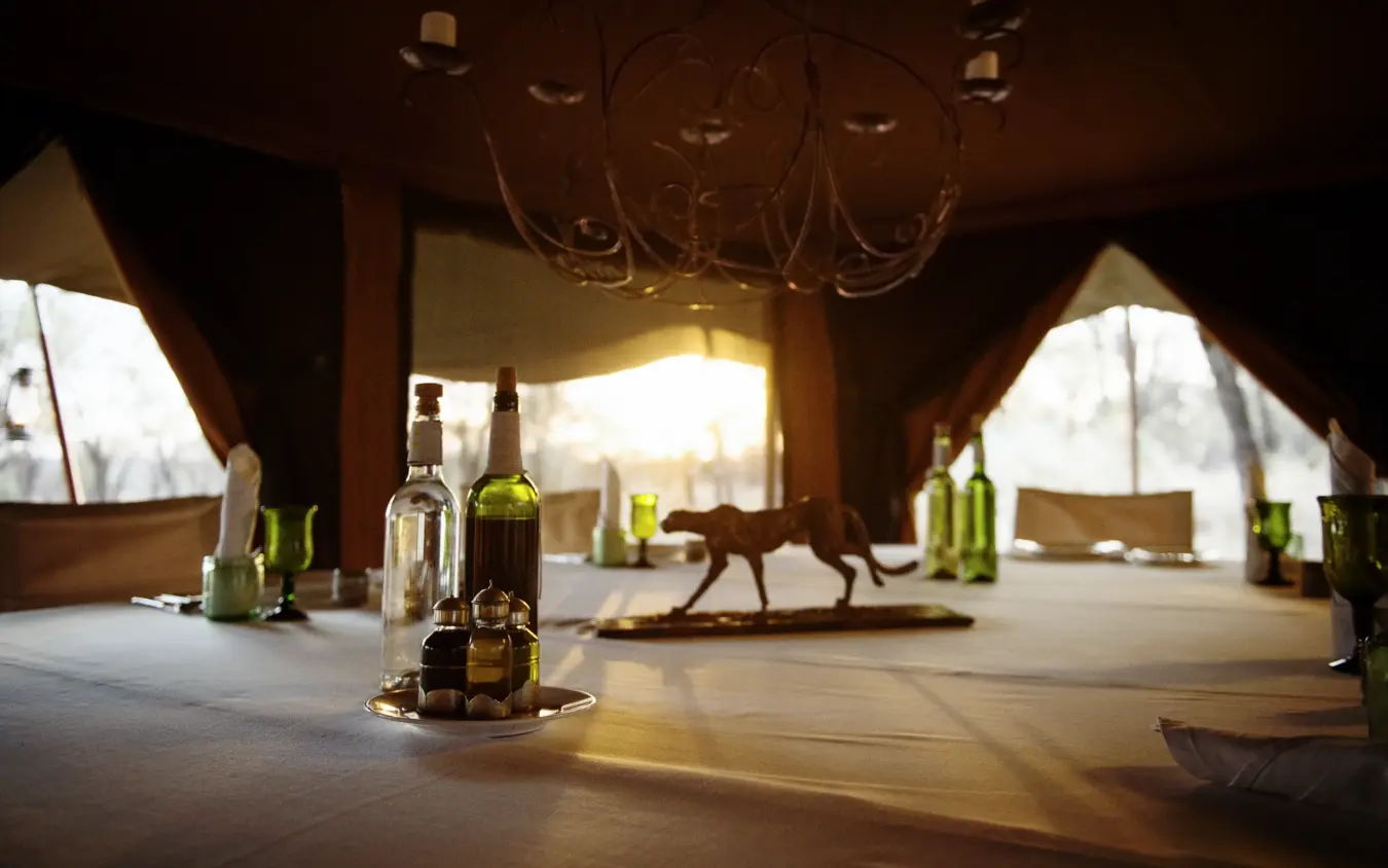 Interior of luxury tent with wine bottles and antelope statue visible, Serian Serengeti Mobile Kusini, Serengeti National Park, Tanzania