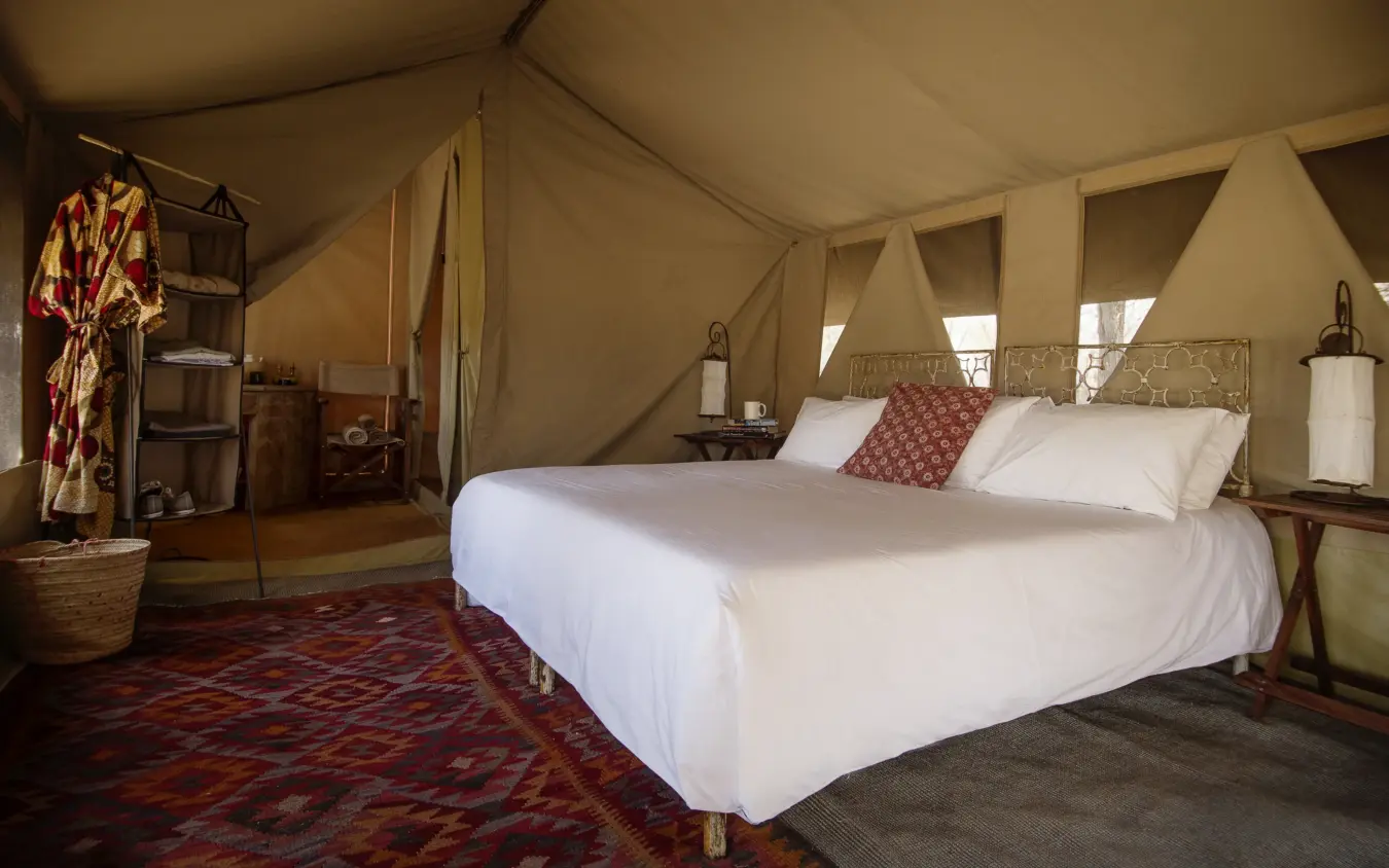 Glamping tent bedroom with canopy bed and canvas walls, Serian Serengeti Mobile Kusini, Serengeti National Park, Tanzania