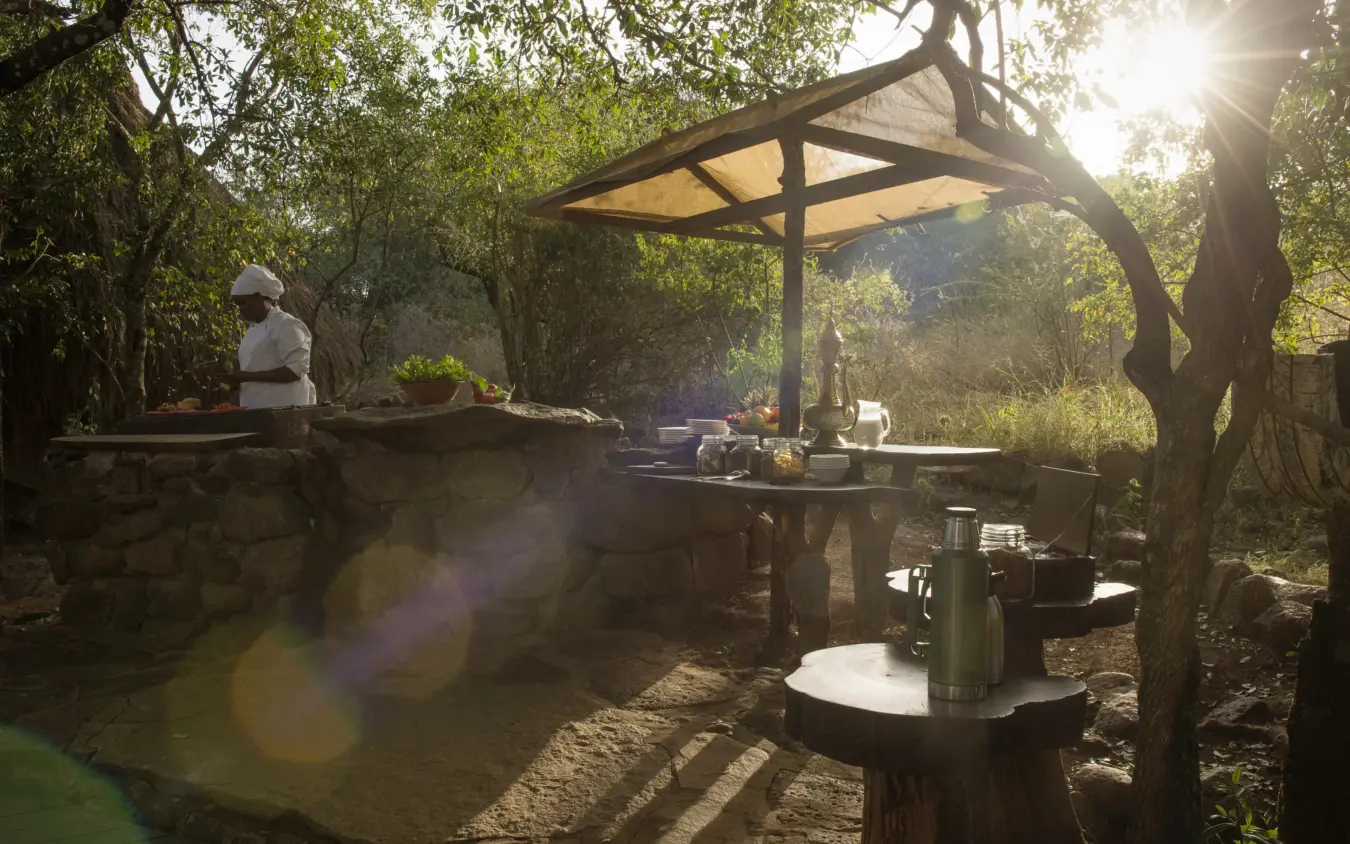 Outdoor kitchen setup beneath wooden pergola in trees, Serian “The Original”, Maasai Mara, Kenya
