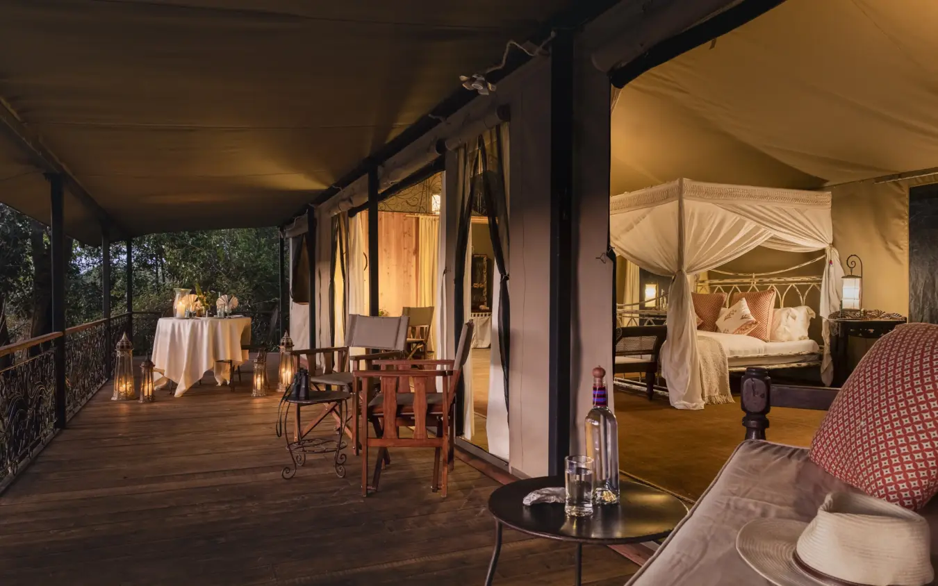 Luxury safari tent with open-air deck and dining area at dusk, Serian “The Original”, Maasai Mara, Kenya