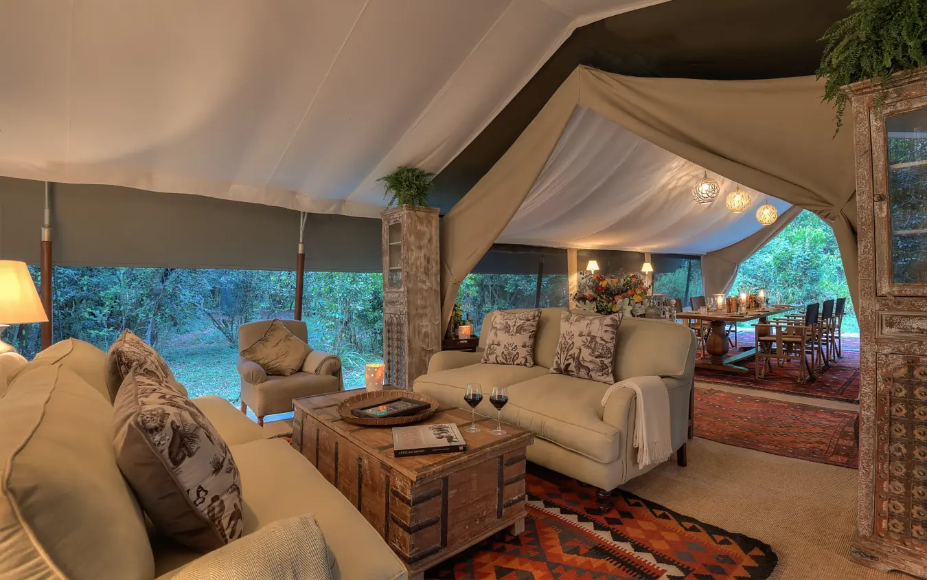Luxury safari lodge interior with canvas roof and forest views at dusk, Seringet Mara Camp, Maasai Mara, Kenya