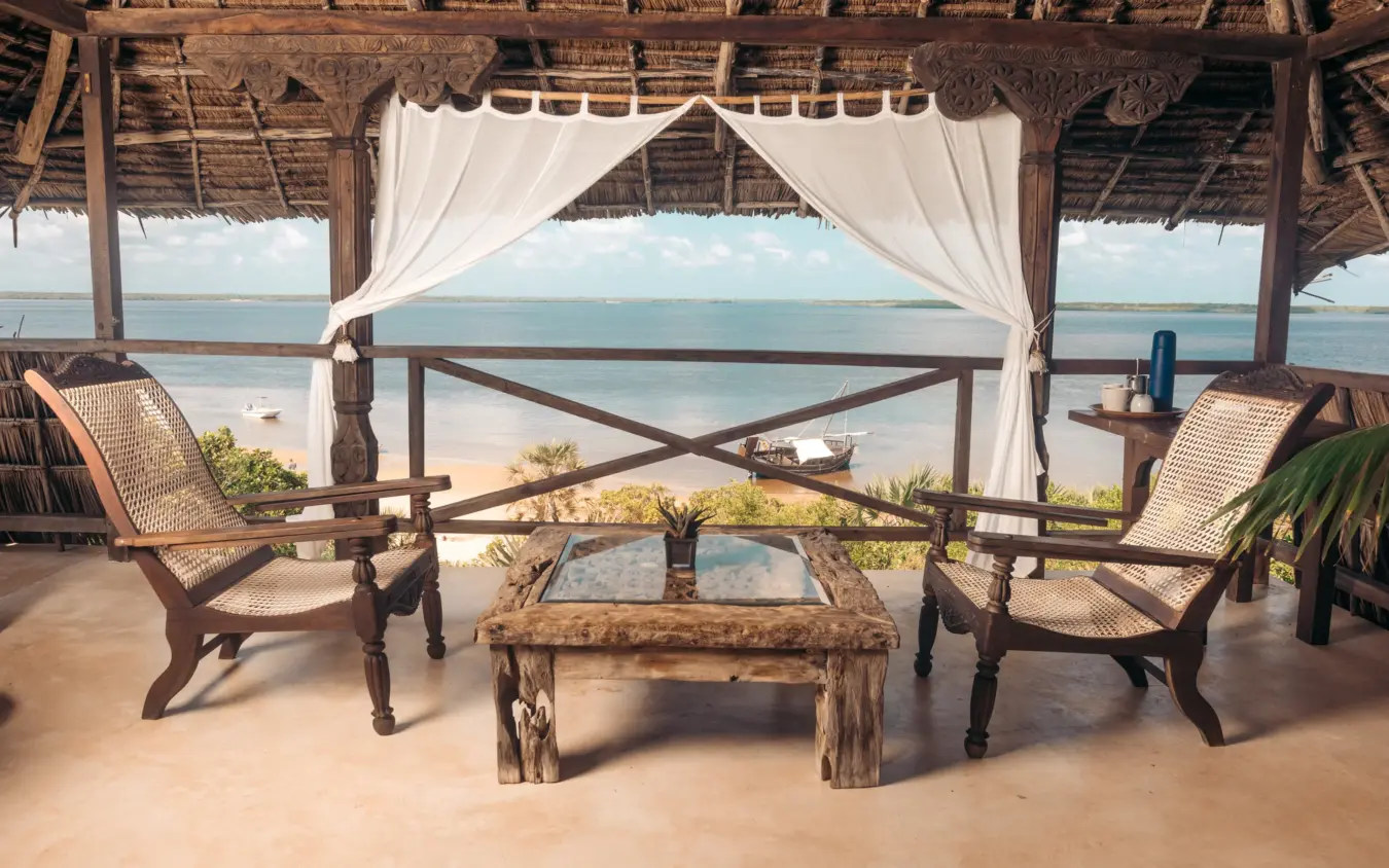 Beachfront pavilion with woven chairs overlooking calm coastal waters, The Cabanas, Lamu Archipelago, Kenya