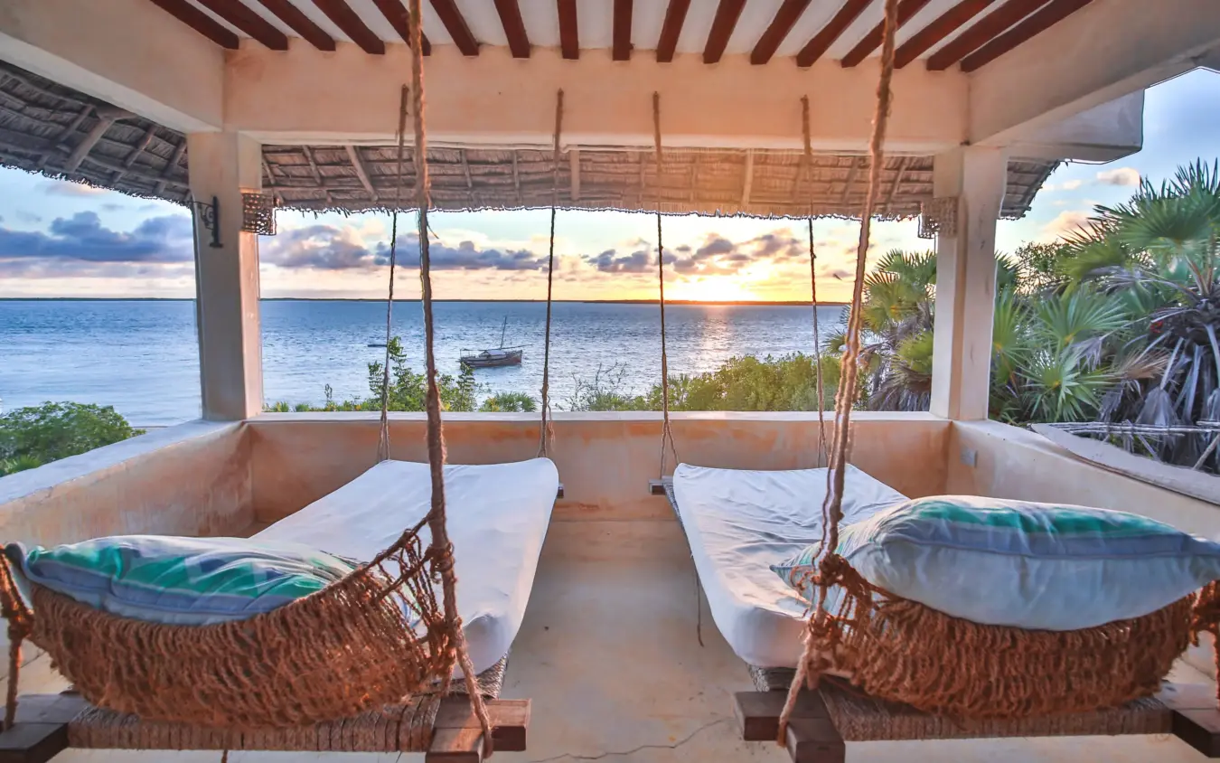 Woven hanging beds on oceanfront pavilion at sunset, The Cabanas, Lamu Archipelago, Kenya
