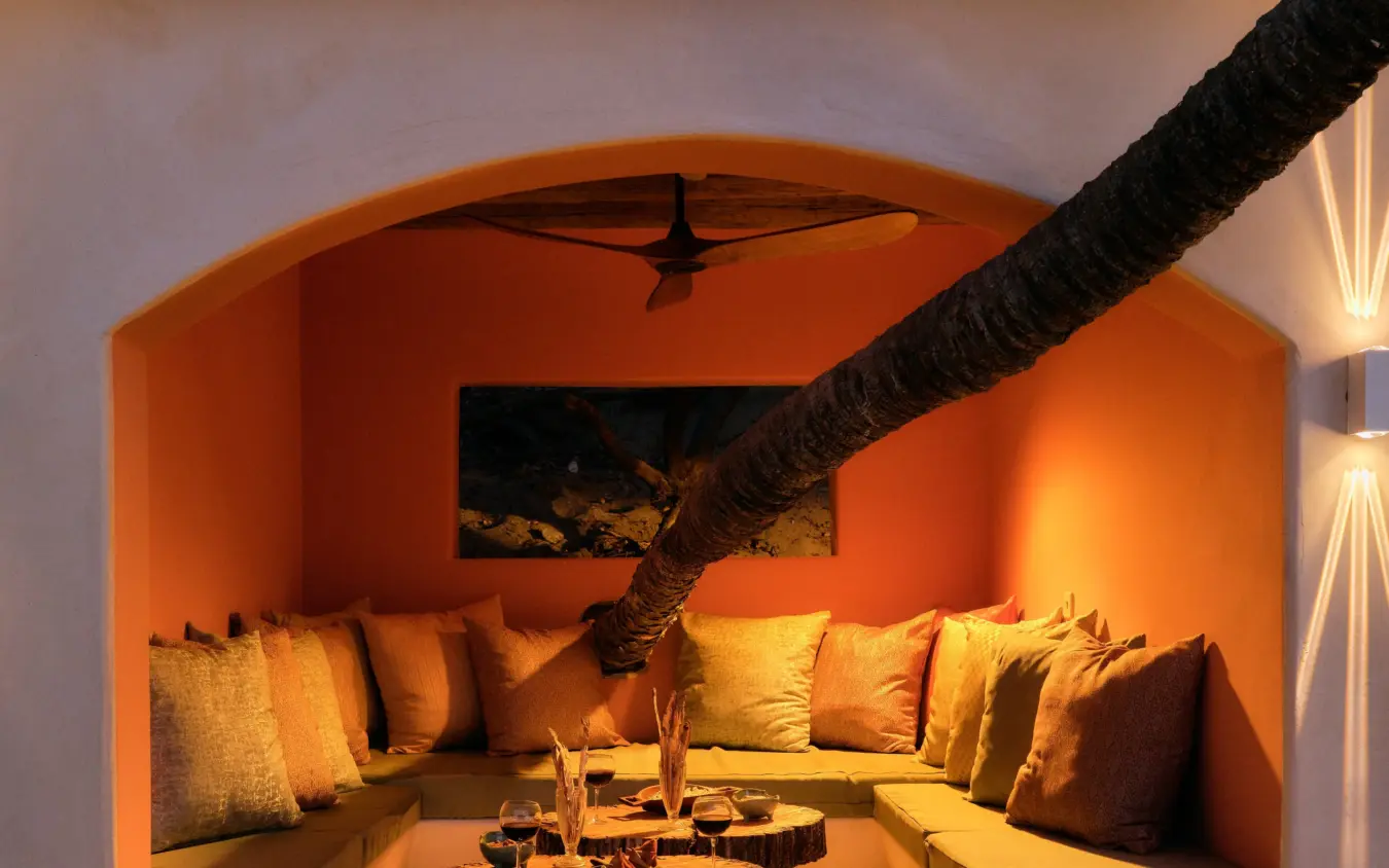 Cozy alcove lounge with tree branch and warm lighting, The Cabanas, Lamu Archipelago, Kenya