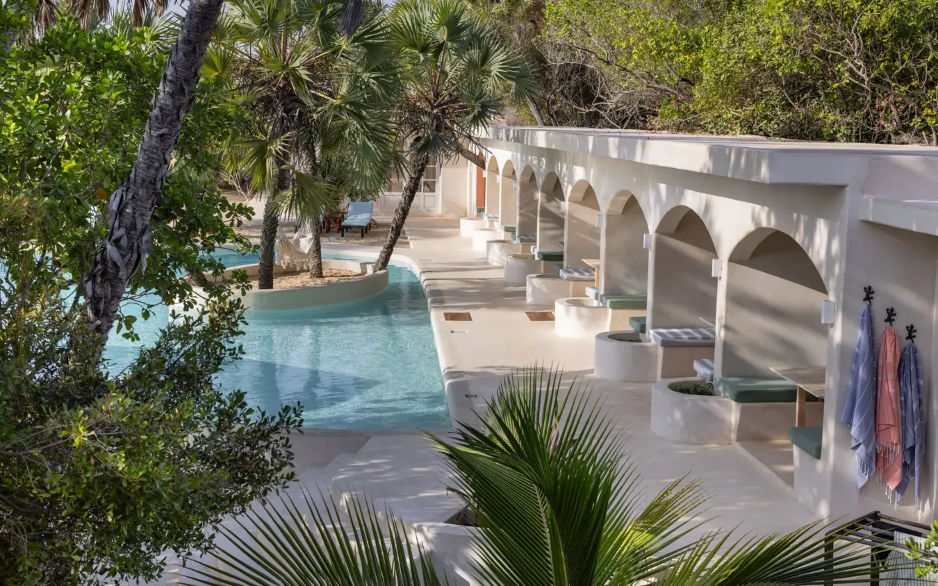 Waterfront lounge with arched architecture and tropical vegetation, The Cabanas, Lamu Archipelago, Kenya