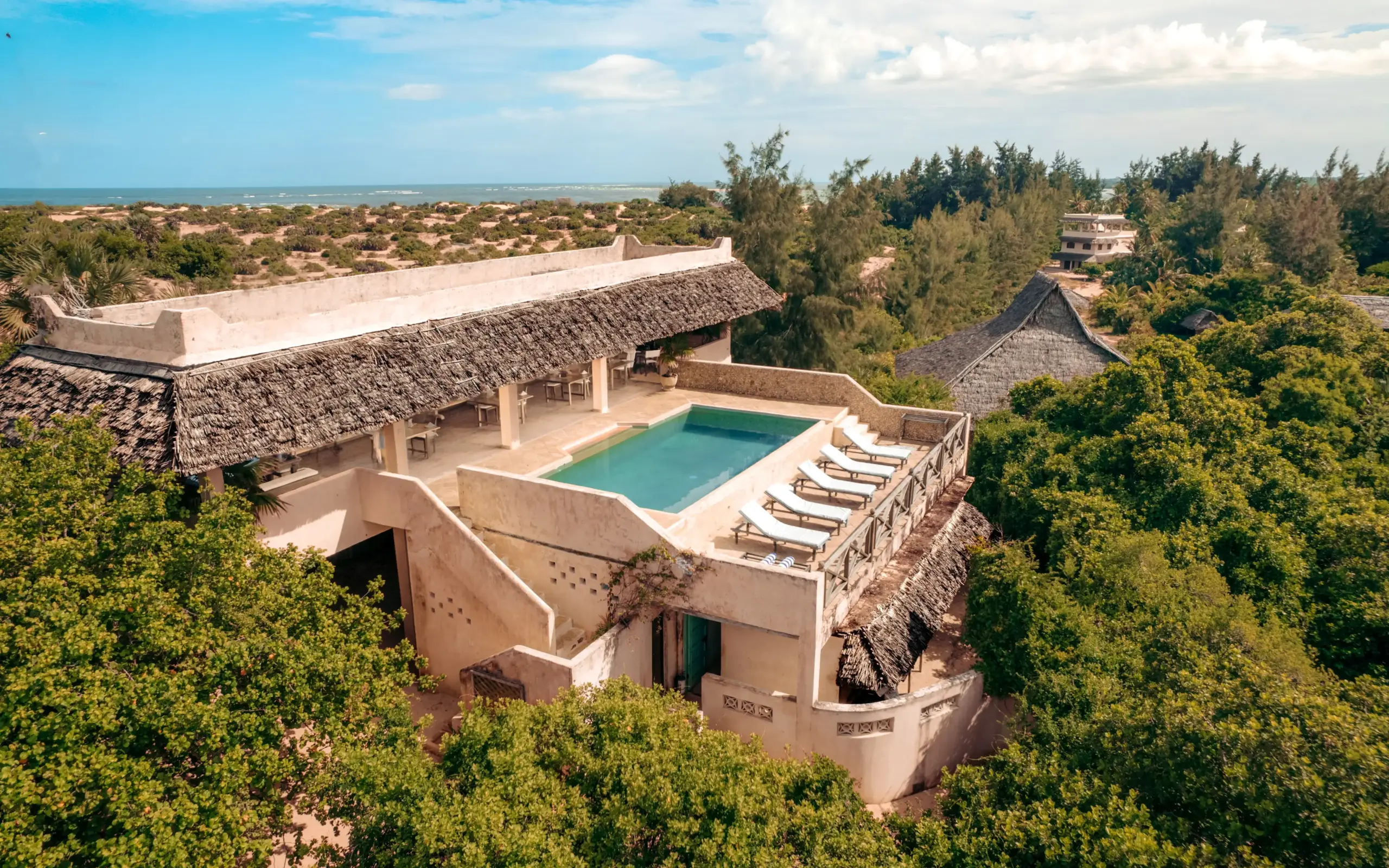 Luxury villa with infinity pool overlooking coastal scrubland and ocean horizon, The Cabanas, Lamu Archipelago, Kenya