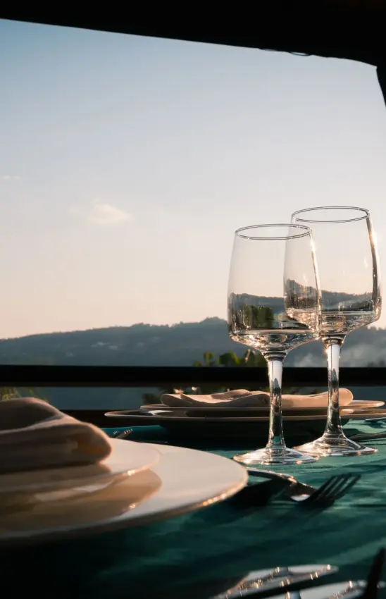 Fine dining table setting overlooking scenic landscape at sunset, Villa Kigali, Kigali, Rwanda