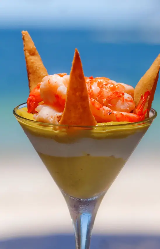 Tropical cocktail with seafood garnish against ocean backdrop, Waterlovers Beach Resort, Diani Beach, Kenya