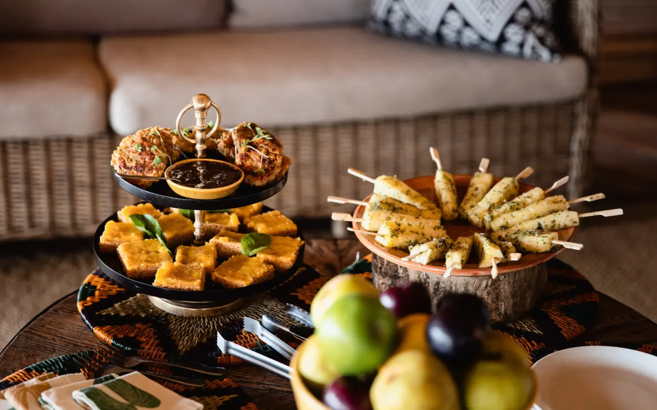 Luxury appetizers and fresh fruit displayed on outdoor lounge table, Savuti Camp, Linyanti Wildlife Reserve, Botswana