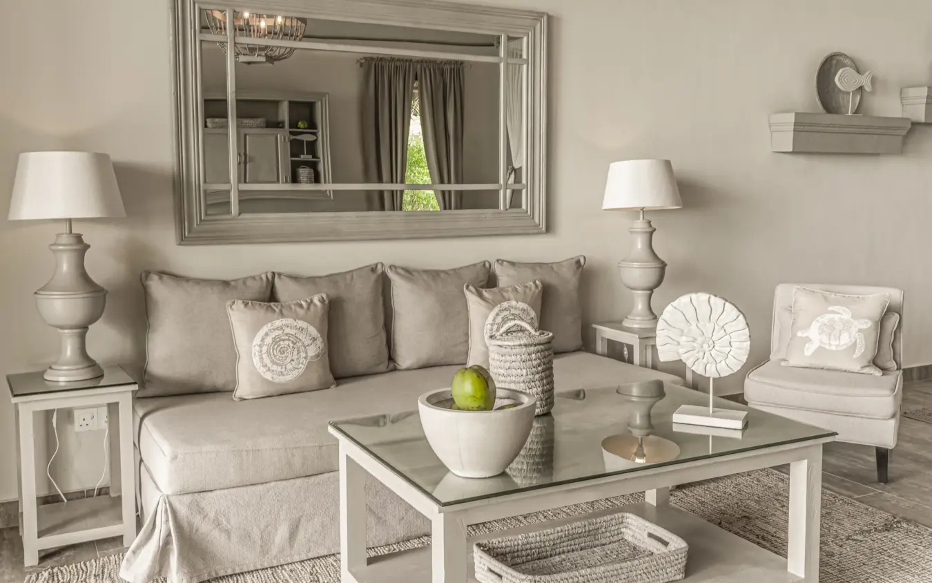 Neutral toned living room with sectional sofa and large mirror, Zawadi Hotel, Zanzibar & Pemba, Tanzania